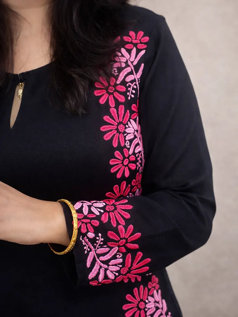 Neckline and upper body detail of black Chikankari kurti with pink hand embroidery