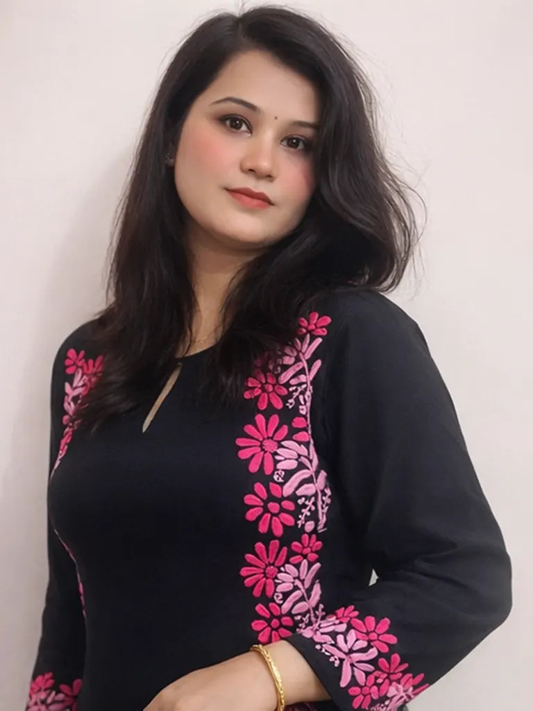 Close-up of pink floral hand embroidery on sleeve of black Chikankari kurti