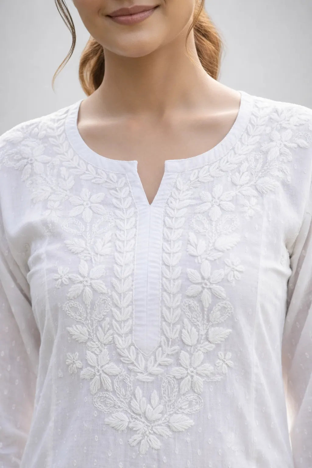 Hand embroidered neckline detail of white Chikankari cotton kurti for women